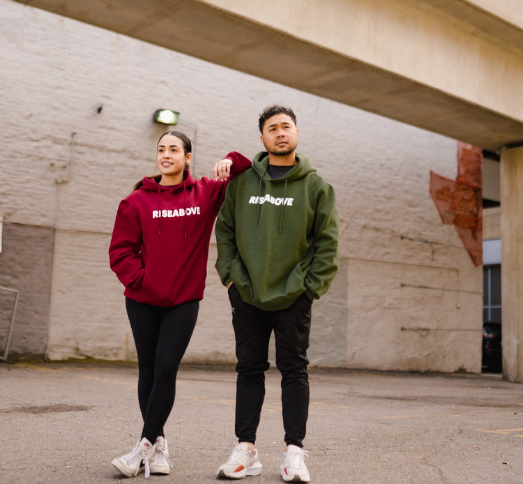 Unisex comfy hoodie symbolizing resilience, paired with mental health shirts and an athletic quarter zip for strength and style.